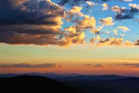 Evening Sunset Sky over mountain silhouettes