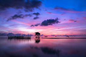 wooden structure on the sea at dusk