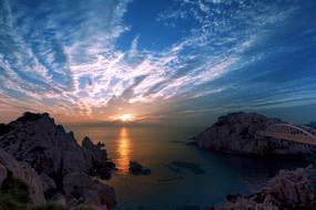 Beautiful waterscape with the rocky coast and colorful sunrise on horizon, in Ulsan, South Korea