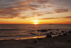 orange sunset in the clouds over the coast in california