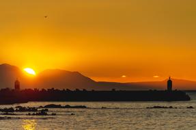 two Lighthouses on Sea coast at sunset
