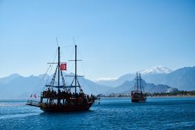 touristic sailing boats on sea at scenic coast