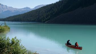 people canoe on Lake Louise in Canada