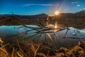 bright setting sun over the mountains on the horizon