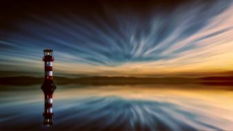 lighthouse on the ocean coast at dusk