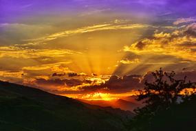 yellow dawn in the clouds over the mountains