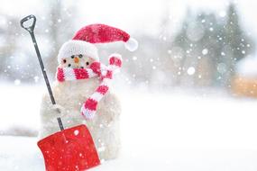 photo of a snowman with a red shovel