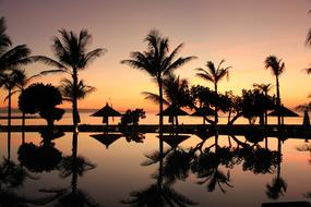 silhouettes of resort in bali at sunset