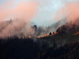 sunset in foggy mountains