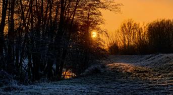 Beautiful and colorful sunset above the river in the forest