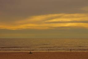 Landscape of the beautiful, sandy beach, at colorful sunset in the sky with clouds