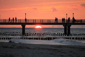 silhouettes of people on the sea bridge in Zingst
