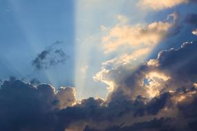 rays of light through thick clouds in the sky