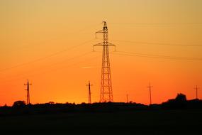 electric power line in countryside at sunset sky