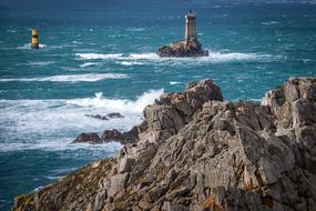 Beautiful landscape with the lighthouse, on the rocks in the Pointe Du Raz in Brittany, France