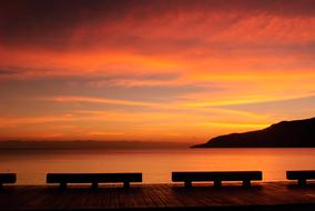 Beautiful shore, at colorful, gradient sunrise in the sky with clouds