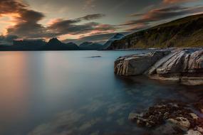 photo of dusk and rocky seashore