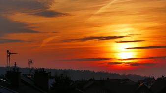 Sunset above village, roof view