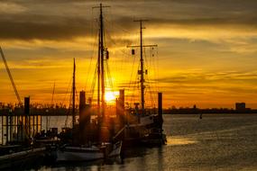 sunset over the horizon on the elbe in hamburg