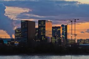 evening panorama of construction cranes and high-rise buildings in Dusseldorf