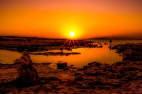 orange sunset over rocky coast