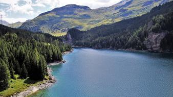 Beautiful landscape of the lake, among the green trees and colorful mountains in Switzerland