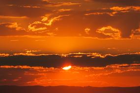 orange sunset in thick clouds in the sky