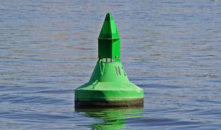 green buoy on the river Elba in the Czech Republic
