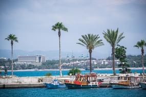 colorful boats in harbor at coastal city, turkey