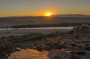 panorama of a rocky plain and river at sunset
