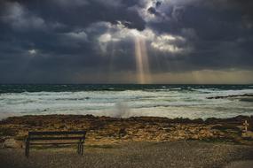 bench by the sea under a stormy sky in Ayia Napa, Cyprus
