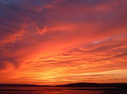 red sunset over the coast on the horizon