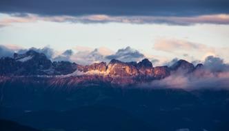 goose fog over the peaks of the alpine mountains in Italy