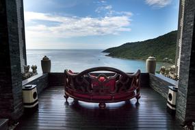Beautiful and colorful terrace of the apartment, with the couch, on the shore in Da Nang, Vietnam