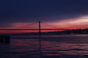 distant view of the silhouette of the great bridge at sunset