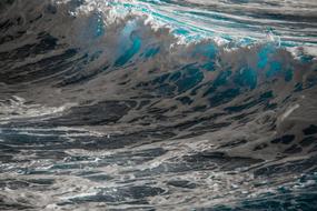 Close-up of the beautiful, turquoise water with the white waves, in the light and shadow