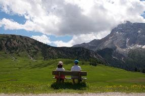 couple on a bench enjoy mountain landscape