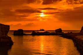 orange sunset on the rocky beach