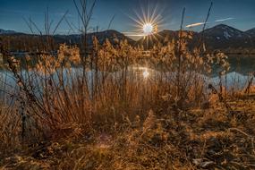 shining Sun setting behind mountains