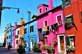 washed clothes hang on the facade of a building in Venice