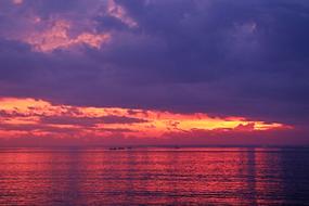 red and purple Clouds above tropical Beach, indonesia, Bali