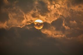 white sun through gray clouds