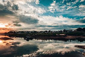 clouds are reflected in water in a picturesque landscape