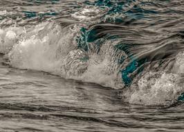 turquoise reflections in the foamy wave of the surf