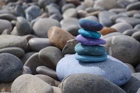 balance of multi-colored pebbles on the beach