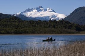 people on a motor boat sail on the river in the taiga