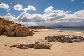 Beautiful sandy coast beach with colorful rocks
