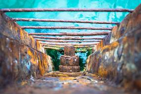 old rusty stairs on the sea close up