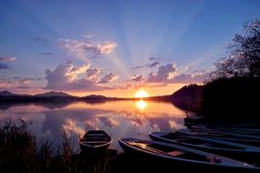 boats on the lake at colorful sunset on the beautiful landscape in Allgau, Germany