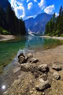 Beautiful landscape of the colorful Braies lake, among the trees and mountains in South Tyrol, Italy